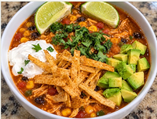 Chicken tortilla soup with avocado, cilantro and tortilla strips