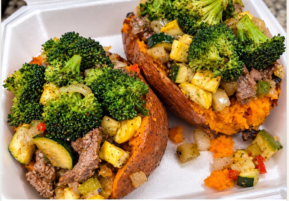 Loaded sweet potato topped with seasoned steak and vegetables